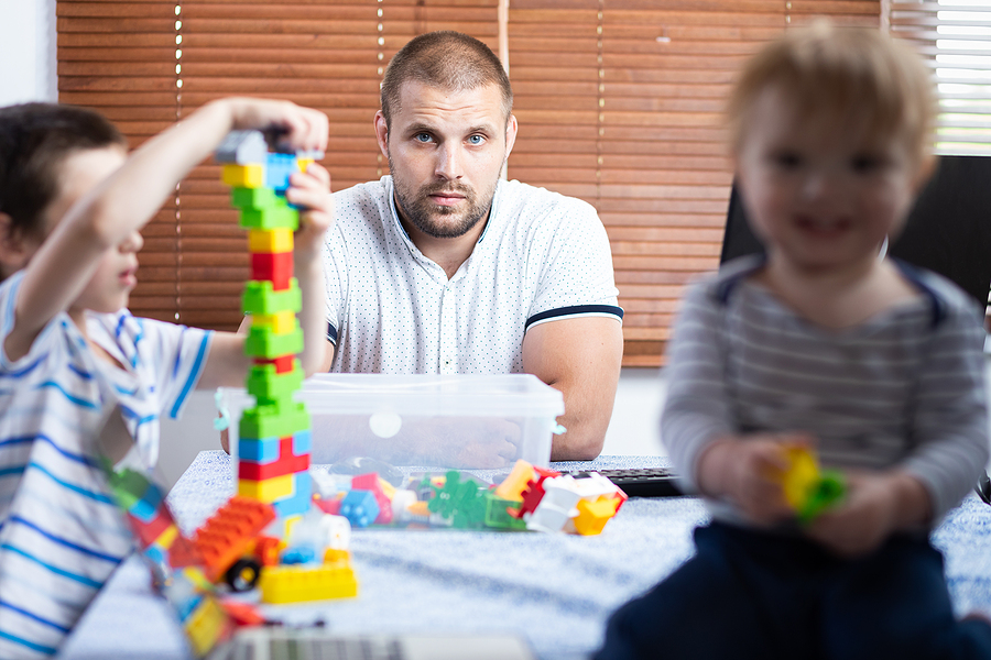 Young father trying to work from home with kids