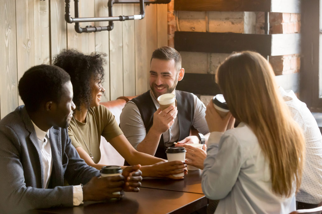 Smiling coworking team having coffee